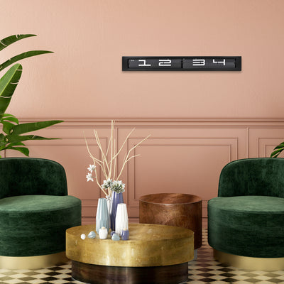 Digitaluhr schwarz in Wohnzimmer an rosafarbener Wand